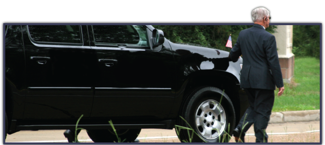 bodyguard in front of black SUV